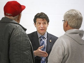 Files: Amherstburg mayor, Aldo DiCarlo, centre, speaks with residents during a public meeting to discuss the proposed 2015 budget at St. Peters A.C.H.S College School, Saturday, March 7, 2015.  (DAX MELMER/The Windsor Star)