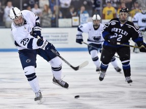 Penn State's Casey Bailey, left, shoot the puck during a game against Bentley at the Pegula Ice Arena.  (Mark Selders/Penn State Athletic Communications)