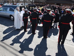 A funeral service for local humanitarian Frank Chauvin was held at Our Lady of Guadalupe Church in Windsor, ON. on Wednesday, March 18, 2015. Windsor Police Honour Guard officers salute Chauvin's casket as it was placed in a hearse. (DAN JANISSE/ The Windsor Star)