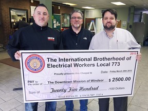 The International Brotherhood of Electrical Workers Local 773 donated $2,500 to the Downtown Mission of Windsor on Friday, March 20, 2015. Karl Lovett, left, business manager/financial secretary for the IBEW and Barry Heeney, assistant business manager, centre, presented the cheque to Ron Dunn, director of development and community relations at the Downtown Mission. DAN JANISSE/The Windsor Star