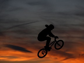 Trevor Tolok, 25, from LaSalle, practices on his BMX at the Vollmer Centre Skateboard Park as the sun sets behind him, Wednesday, March 18, 2015.  (DAX MELMER/The Windsor Star)