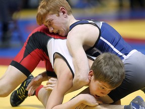 Brett Hodgkin (top) of Sandwich and Alexander Stirling of Orillia District compete in the gold medal match in the boys 41 KG division during OFSAA wrestling championships at the WFCU Centre in Windsor, ON. on Wednesday, March 4, 2015. (DAN JANISSE/ The Windsor Star)