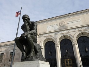 In a photo from Tuesday, Dec. 10, 2013 at the Detroit Institute of Arts in Detroit, The Thinker, a sculpture by Auguste Rodin is seen outside the art museum.
