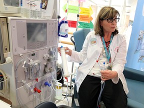 Nurse Madeline Power shows how a dialysis machine works at Windsor Regional Hospital on World Kidney Day, Mar. 12, 2015. (Tyler Brownbridge / The Windsor Star)