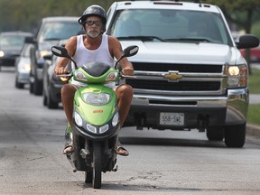 An e-bike rider cruises along Giles Boulevard East in Windsor in this 2011 file photo. (Dan Janisse / The Windsor Star)