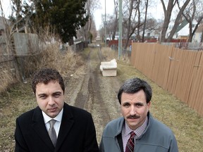 Fabio Costante (L), founder of the Our West End initiative, and Barry Horrobin, director of planning with Windsor police, stand in an alley in the city's west side on March 30, 2015. (Tyler Brownbridge / The Windsor Star)