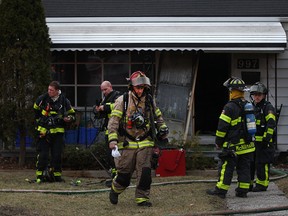 Fire crews work at the scene of a house fire at 997 McKay Ave, Monday, March 16, 2016.  (DAX MELMER/The Windsor Star)