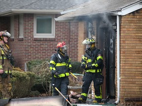 Windsor fire crews work on a house fire at 2497 Everts Ave., Sunday, March 29, 2015.   (DAX MELMER/The Windsor Star)
