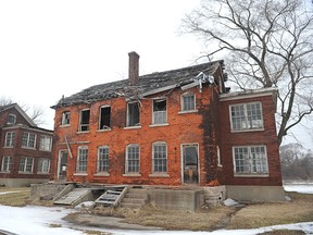 In this March 10, 2015 photo shows historic buildings along Officer's Row in need of repair in Detroit.  Michigan has hired a New York City firm to look at ways to revive Historic Fort Wayne, a long underused 96-acre site along the Detroit River. The Michigan Economic Development Corp. in January hired HR&A Advisors Inc. for $235,000 with the goal of coming up with a realistic plan that would maintain the fort's historic nature while incorporating other uses for the property.  (AP Photo/Detroit News, Max Ortiz)