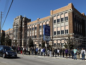 Students line the sidewalk in front of Walkerville High School in Windsor as the body of teacher Robert Baxter passes by enroute the cemetery on Tuesday, March 24, 2015.              (TYLER BROWNBRIDGE/The Windsor Star)