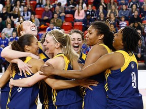 Korissa Williams, from left, Emily Prevost, Caitlyn
Longmuir, Andrea Kiss,
Cheyanne Roger and Chidera Ifearulundu celebrate after the Lancers won their fifth straight CIS women's basketball championship Sunday, March 15, 2015 l in Quebec City.  (Yan Doublet/Special to the Star)