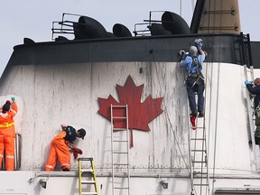 After a long stretch of ice-breaking, crew members work clean up duty on the Canadian Coast Guard Griffon while it was docked in Windsor, ON. on Monday, March 16, 2015. (DAN JANISSE/ The Windsor Star)
