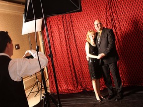John Liviero of Sooters Photography, left, photographs Laurie and Paul Guidolin at the Give Your Heart to Autism Gala Saturday, Feb. 28, 2015 at the Giovanni Caboto Club. The event is hosted by Autism Ontario Windsor/Essex chapter. (RICK DAWES/The Windsor Star)