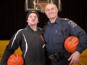 Kyle Jones, 27, left, an athlete with the Amherstburg Heroes Athletic Club, is pictured with Sgt. Mike Cox of the Amherstburg Police Service at General Amherst High School, Friday, March 27, 2015.  The athletic club is a partnership between Community Living Essex County and the Amherstburg Police Service.  (DAX MELMER/The Windsor Star)