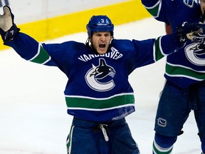 Vancouver Canucks' Kevin Bieksa celebrates his winning goal against the Phoenix Coyotes during overtime NHL hockey action in Vancouver, B.C., on Sunday January 26, 2014. THE CANADIAN PRESS/Darryl Dyck