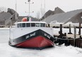 The fishing boat Edith Marie !!, shown Thursday, March 19, 2015, is stuck in the foot thick ice at the Kingsville Harbour. (DAN JANISSE/ The Windsor Star)
