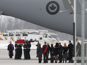 Military pallbearers from the Canadian Special Operations Forces Command carry the flag-draped casket of Sgt. Andrew Joseph Doiron at Canadian Forces Base Trenton in Trenton, Ont., on Tuesday March 10, 2015. Sgt. Doiron was killed by friendly fire during operation Impact on March 6, in northern Iraq. THE CANADIAN PRESS/Lars