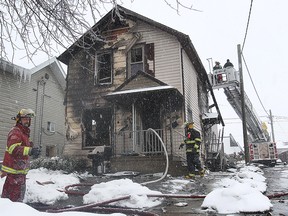 Leamington firefighters make sure the flames are extinguished at a house fire on Marlboroguh Street West on Mar. 3, 2015. (Dan Janisse / The Windsor Star)
