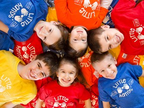 Clockwise from top: Teya Mastronardi, Noah Egglezos, Mateah Egglezos, Nataliah Egglezos, Micah Egglezos, and Cole Mastronardi lay in a pile of Little Hands for a Cause t-shirts. Little Hands for a Cause was founded last summer by their mothers, Leigh Ann Mastronardi and Aimee Omstead, and has raised thousands of dollars for children with life-threatening illnesses.  (Gabrielle Smith/Special to The Star)