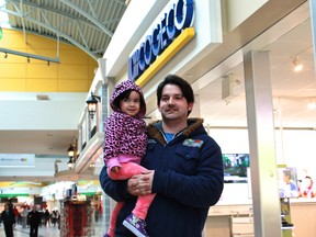 Les Geauvreau and his daughter Sateal were at the Devonshire Mall shopping for a new phone with his wife on Thursday, Mar. 19, 2015. Geauvreau said that he pays too much for his cable plan and might consider switching over to the $25 "skinny basic" plan the CRTC announced is required of cable and satellite companies in 2016. (JAY RANKIN/The Windsor Star)