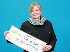 Mary-Joyce Gural of Windsor shows the $100,000 cheque she won from playing a game of Instant Crossword Tripler scratch game. (Handout / The Windsor Star)