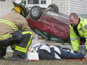 Emergency personnel work at the scene of a motor vehicle accident at the intersection of Milloy St. and Francois Rd., Monday, March 30, 2015. (DAX MELMER/The Windsor Star)
