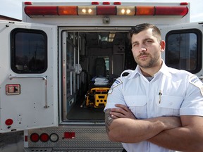 Patrick Lomascolo, a patient transfer attendant, is pictured next to a Community Patient Transfer Group vehicle, Sunday, March 15, 2015.   (DAX MELMER/The Windsor Star)