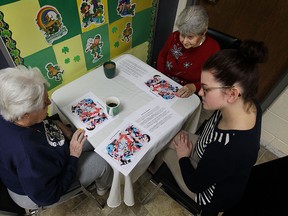 Penny Dixon, left, and Beatrice Gerard work on puzzles with the help of Lauryn Fraser at the Alzheimer Society of Windsor and Essex County in Windsor on  March 10, 2015. Seniors with early symptoms of dementia take part in puzzles and games to help keep their minds in shape.        (TYLER BROWNBRIDGE/The Windsor Star)