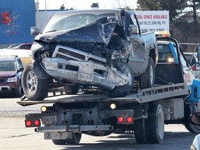 A damaged truck is taken away from the Devonshire Mall on Thursday, March 12, 2015, after is crashed into the west wall of the Sears store. The driver of the vehicle was taken to hospital with unknown injuries. (DAN JANISSE/ The Windsor Star)