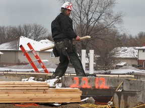 House framer Chris Gignac works on a new home in the Blue Heron Lake area of Windsor, Ont. on Tuesday, April 15, 2014. (DAN JANISSE/The Windsor Star)