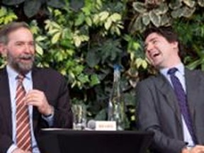 Liberal Leader Justin Trudeau laughs with NDP Leader Tom Mulcair as he speaks during a panel discussion on youth voting, Wednesday, March 26, 2014 in Ottawa. Mulcair is reiterating his openness to a possible coalition with the Liberals if it is necessary to topple Stephen Harper's Conservatives. THE CANADIAN PRESS/Adrian Wyld