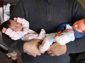 Newborn twins Madelyn (L) and Jaxson Santos are shown in the arms of their father Kingsville mayor Nelson Santos on Thursday, March 19, 2015. The young mayor and family welcomed the twins to his growing family two weeks ago. (DAN JANISSE/ The Windsor Star)