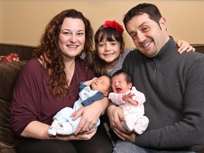 KINGSVILLE, ON. MARCH 19, 2015. Kingsville Mayor Nelson Santos poses with his wife Stephanie, daughter Emelia, 6, and newborn twins Jaxson and Madelyn at their home on Thursday, March 19, 2015. The young mayor and family welcomed the twins to his growing family two weeks ago. So far Jaxson (L) has been the laid back relaxed baby while Madelyn has been the spirited vocal twin. (DAN JANISSE/ The Windsor Star)