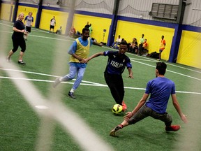 Goalie Ali Breesam, right, attempts to make a save during the 2nd annual Somali Community Soccer Tournament, March 20, 2015, held at the Novelleto Rosati Sports Complex. Citizens and police team up to host the event with the goal of improving police-community relationships. (RICK DAWES/The Windsor Star)
