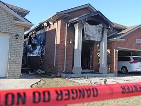 Red caution tape surrounds two homes on the 4200 block of Spago Cres., Monday, March 30, 2015, after a house fire yesterday evening.  An OFM investigator will be attending the scene today.  (DAX MELMER/The Windsor Star)