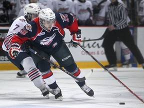 Windsor's Sam Povorozniouk brings the puck up the ice while being defended by Oshawa's Chris Carlisle during OHL action between the Windsor Spitfires and the visiting Oshawa Generals at the WFCU Centre, Sunday, March 8, 2015.  (DAX MELMER/The Windsor Star)