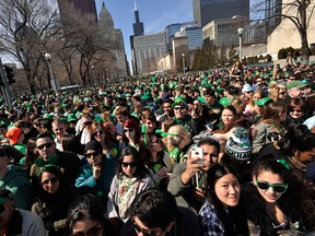 A large crowd watches the St. Patrick's Day parade in Chicago, Saturday, March 14, 2015. (AP Photo/Paul Beaty)