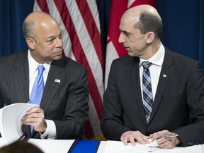 Homeland Security Secretary  Jeh Johnson, left, and Canadian Minister of Public Safety and Emergency Preparedness Steven Blaney signed a historic pre-clearance agreement on March 16 as part of the Beyond the Border Initiative. (AP Photo/ Evan Vucci)