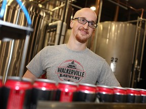 Blayne Caron, assistant brewer at the Walkerville Brewery, works the canning line for the brewery's new line of 16oz Honest Lager tallboys, Monday, March 9, 2015.  The cans will be sold at LCBO stores. (DAX MELMER/The Windsor Star)