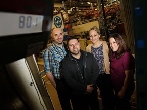 Windsor Mold employees Romeo Tilo, left, Boula Jabbour, Melissa Peric and Colleen Rauth on the shipping scale at their plant March 10, 2015. The four employees are taking part in a biggest loser challenge.  (TYLER BROWNBRIDGE/The Windsor Star)
