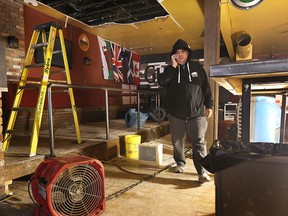 The Manchester will be back in business this weekend. A few weeks ago, the establishment sustained significant water damage after flooding in a nearby condo building. Here, owner Tom Sotiriadas checks out the damage to his bar on Feb. 23, 2015. (DAN JANISSE / The Windsor Star)