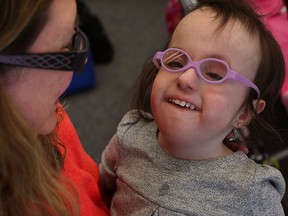 John McGivney Children's Centre preschool student Madison Walsh, 3, smiles while being held by her mother Lena Walsh, April 01, 2015.  The 30-year preschool program is being shut down due to lack of funding and many families are concerned. (NICK BRANCACCIO/The Windsor Star)