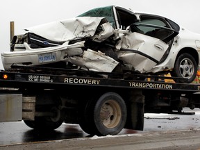 Windsor, ON. April 02, 2015  Myers Towing operator prepares to remove a Chevrolet sedan after the driver was rescued by Windsor firefighters and Essex-Windsor EMS paramedics following a multi-vehicle crash on Highway 3 just west of St. Clair College main campus.  The collision snarled traffic in the entire south end of city, April 02, 2015.  One woman was taken to hospital with multiple fractures. OPP had both east and west bound Highway 3 re-routed until vehicles were towed away.  (NICK BRANCACCIO/The Windsor Star)
