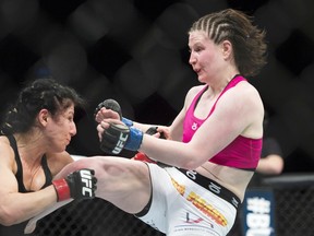 Ransa Markos, of Windsor, trades blows with Aishling Daly, right, from Ireland, during their UFC 186 fight in Montreal, Saturday, April 25, 2015. THE CANADIAN PRESS/Graham Hughes