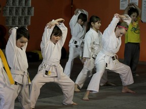Young members of a karate and jiu-jitsu martial arts class at Hybrid Training Academy practice their moves on April 8, 2015. (NICK BRANCACCIO/The Windsor Star)