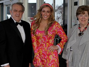 Dapper Dr. John Strasser, left, and his wife Gayle Strasser, right, pose with Travel and Tourism student Montana Daneliuk at St Clair College 25th Annual Gourmet Wine and Food Gala held at St. Clair Collge Centre for the Arts Friday April 10, 2015. (NICK BRANCACCIO/The Windsor Star)