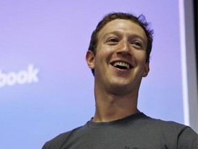 FILE - Facebook CEO Mark Zuckerberg smiles during an announcement at Facebook headquarters in Palo Alto, Calif., in this July 6, 2011 file photo. Facebook and its founder must release documents and electronic correspondence to a defense lawyer whose client has fled from criminal charges that he falsely claimed a majority ownership in the social media giant, a federal judge said Friday April 3, 2015. (AP Photo/Paul Sakuma, File)