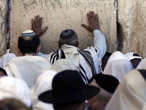 Jewish men draped in prayer shawls perform the Cohanim prayer (priest’s blessing) during the Pesach (Passover) holiday at the Western Wall in the Old City of Jerusalem on April 6, 2015. Thousands of Jews make the pilgrimage to Jerusalem during the eight-day Pesach holiday, which commemorates the Israelites’ exodus from slavery in Egypt some 3,500 years ago and their plight by refraining from eating leavened food products.