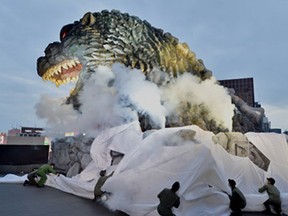 A life-size Godzilla head on a balcony of the eighth floor of Hotel Gracery Shinjuku is displayed during the official unveiling ceremony at Kabukicho shopping district in Tokyo on April 9, 2015. The Godzilla is a main feature of the new commercial complex comprising a 970-room hotel, movie theatres and restaurants which will be open this month.
