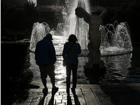 eople watch the fountains in front of Caesars Palace in Las Vegas. (AP Photo/John Locher)